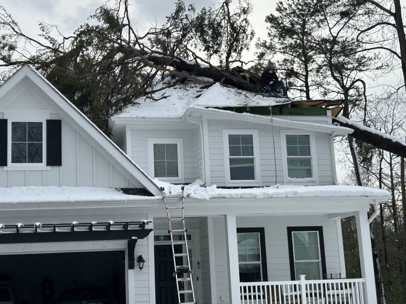 A tree hammered the second floor of a Milton house on Chandler Street in Milton after heavy snow forced it down. KEVIN SPENCE PHOTO